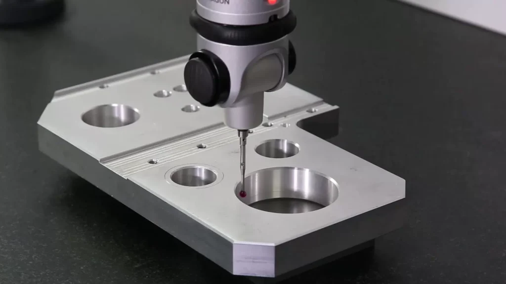 Coordinate measuring machine conducting high precision dimensional inspection on CNC machined aluminum workpiece to guarantee machining tolerance