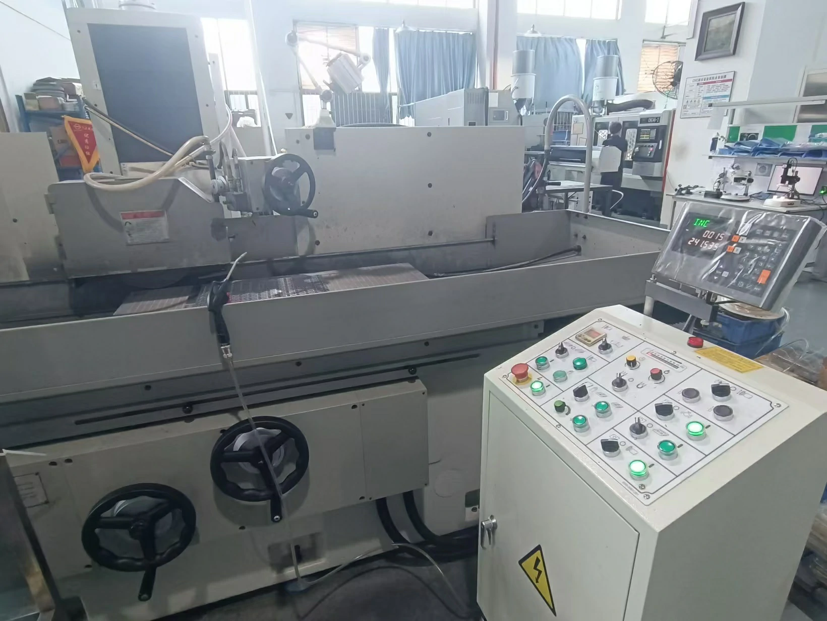 Industrial surface grinder with digital control panel for fine surface finishing of CNC machined metal workpieces
